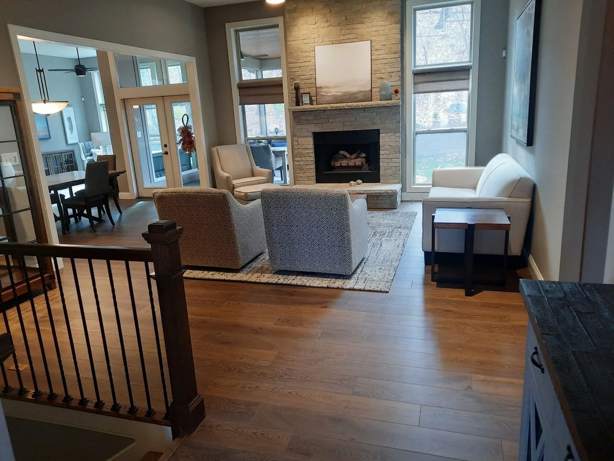 Hardwood flooring installed by Veteran Flooring in a St. Louis area living room with a stone fireplace